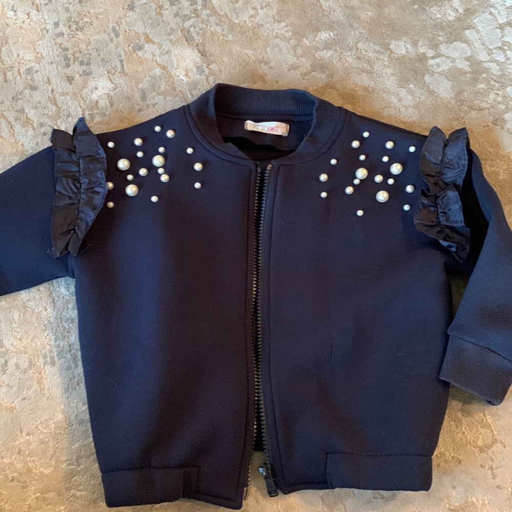 Navy blue pearl embellished ruffle sleeve sweatshirt jacket.